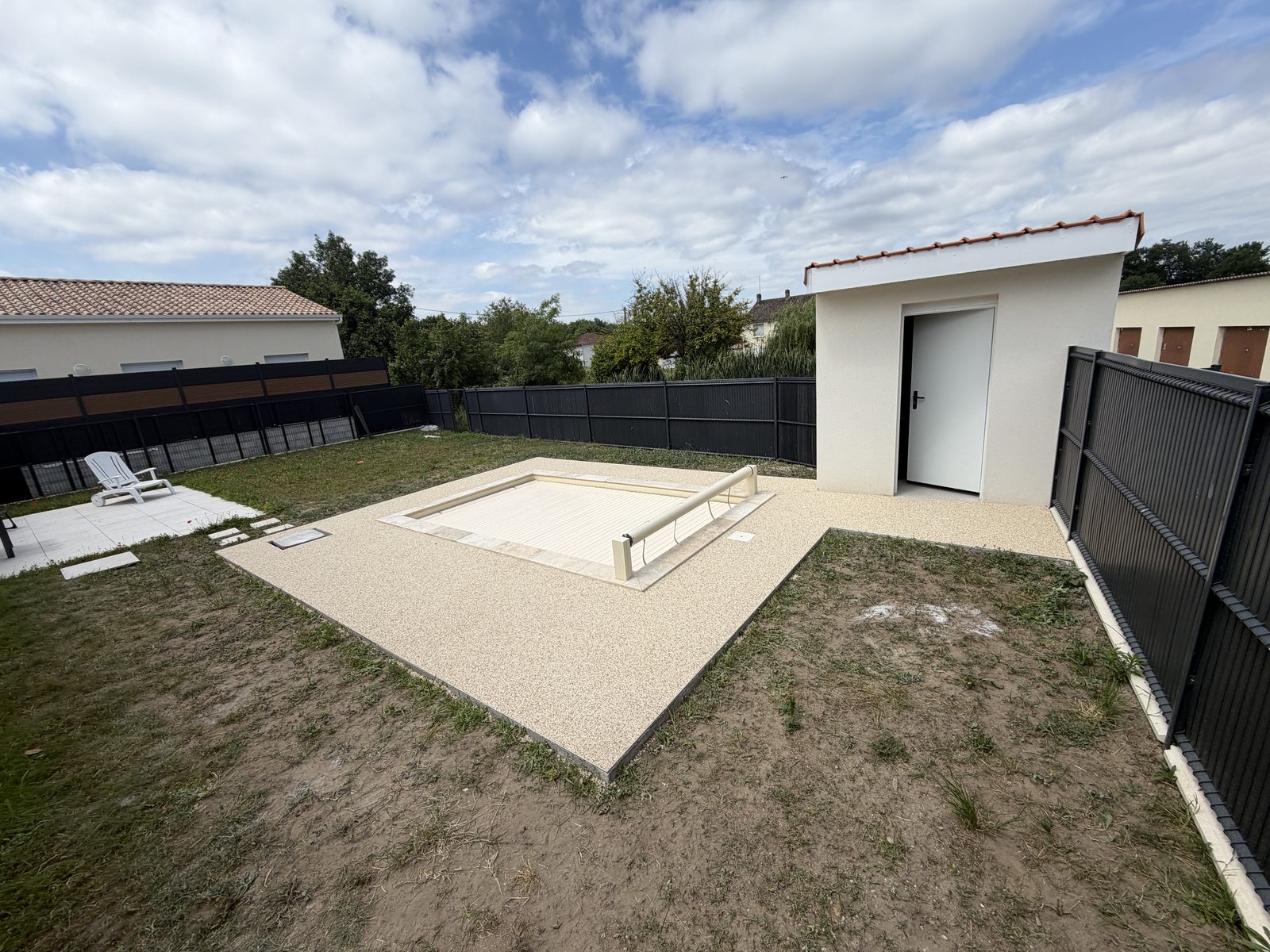 La même plage de piscine après la pose de la moquette de pierre beige